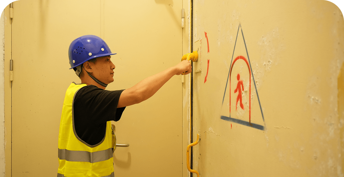 Man in hard hat and vest at door
